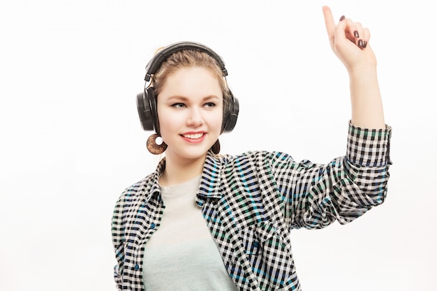 Young woman in headphones dancing and smiling