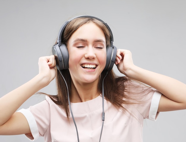 young woman in headphones listening to music