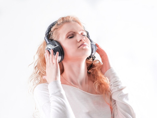 Young woman in headphones listening to music