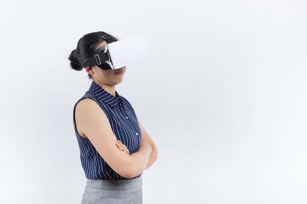 Young woman in her 30s using virtual reality goggles Woman wearing VR headset isolated over yellow banner VR experience concept