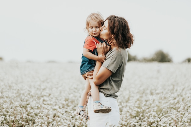 Young woman and her daughter with curly hair