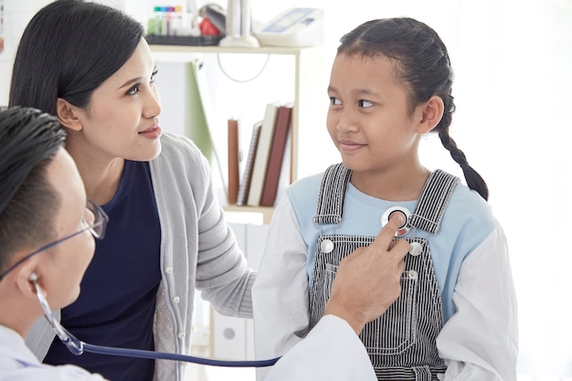 Young woman and her little daughter with pediatrician