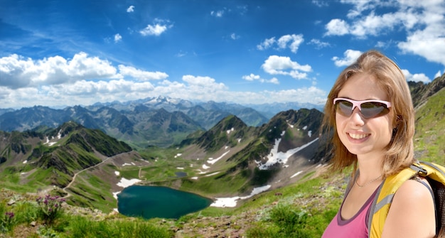 Young woman hiker and lake Oncet in the French mountains pyrenees