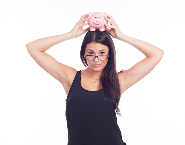 Young woman hold a piggy bank