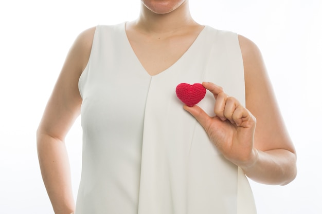 young woman hold red heart sign 