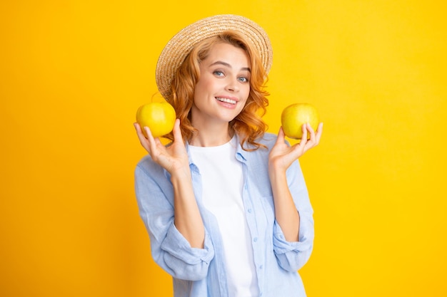 Young woman holding apples looking at the camera with sexy expression cheerful and happy face