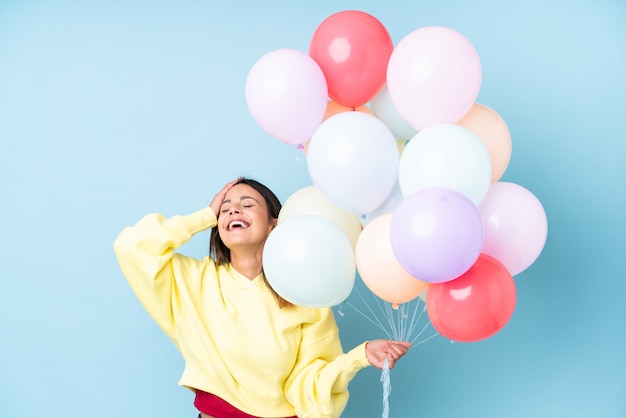 Young woman holding balloons