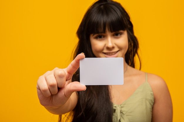 Young woman holding blank white business card