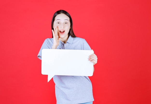 Young woman holding board and laughing