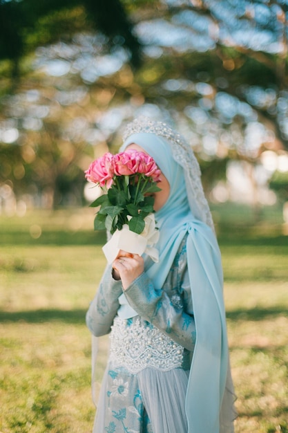 young woman holding a bouquet of roses