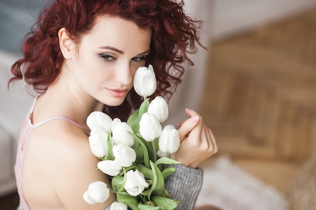 Young woman holding a bouquet of tulips