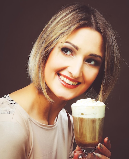 Young woman holding cafe latte cup