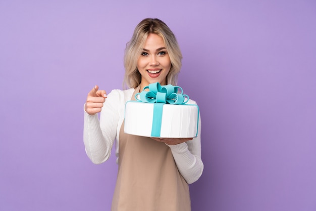 Young woman holding a cake