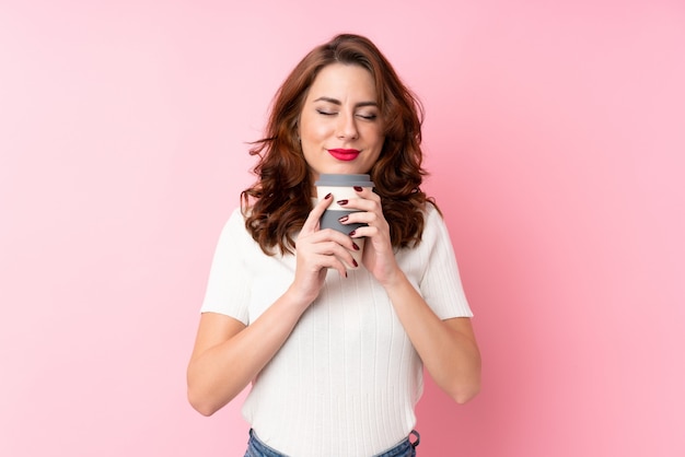 Young woman holding coffee to take away