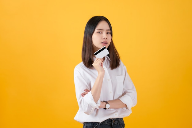 Young woman holding credit card payment