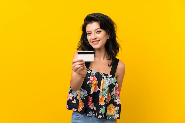 Young woman holding a credit card