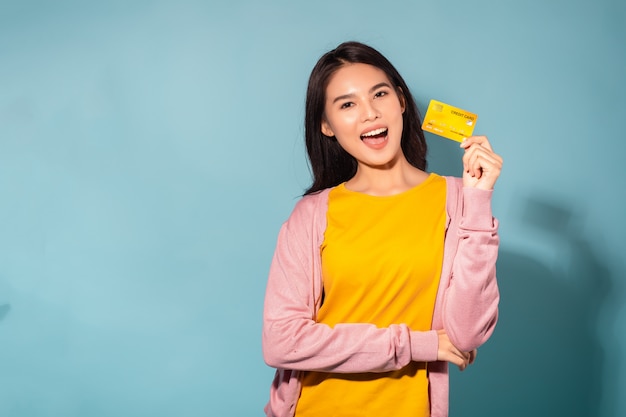 Young woman holding a credit card