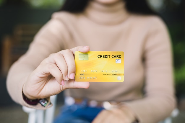 Young woman holding credit card