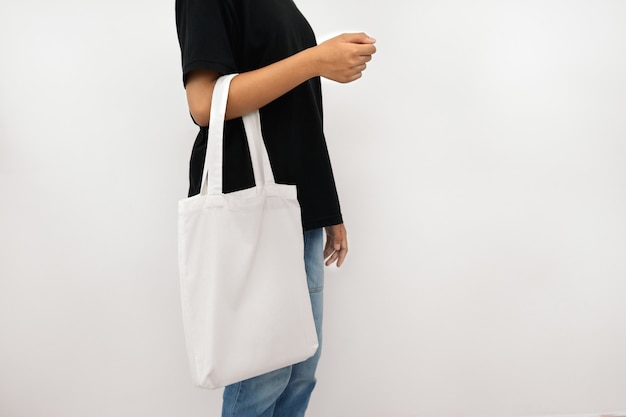 Young woman holding eco cotton bag isolate on white