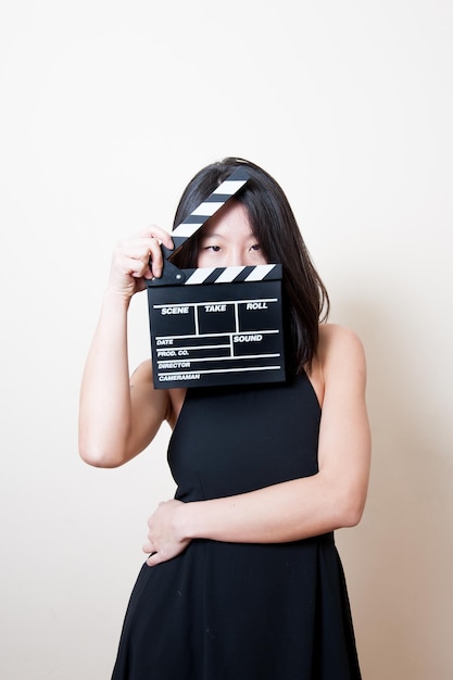 Photo young woman holding film slate