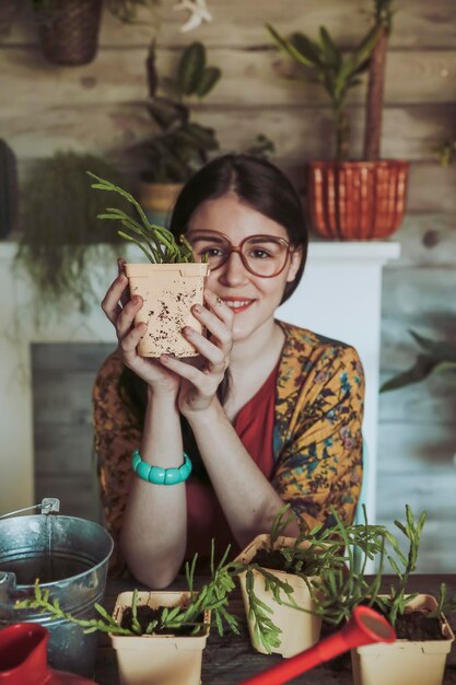 Young woman holding freshly potted cactus