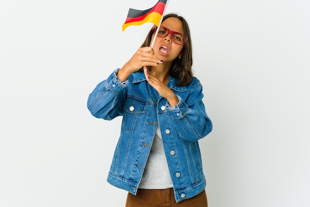 Young woman holding a german flag isolated on white wall showing a timeout gesture