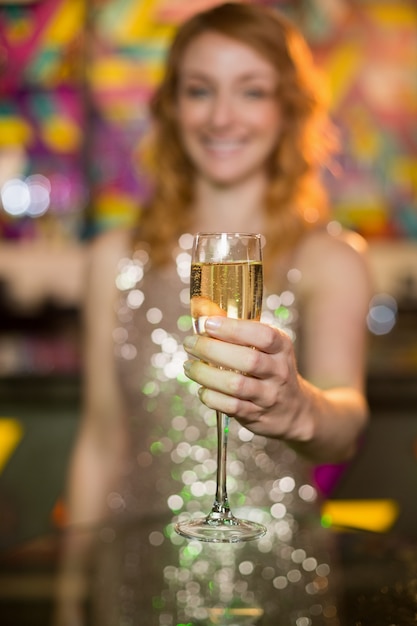 Young woman holding a glass of champagne