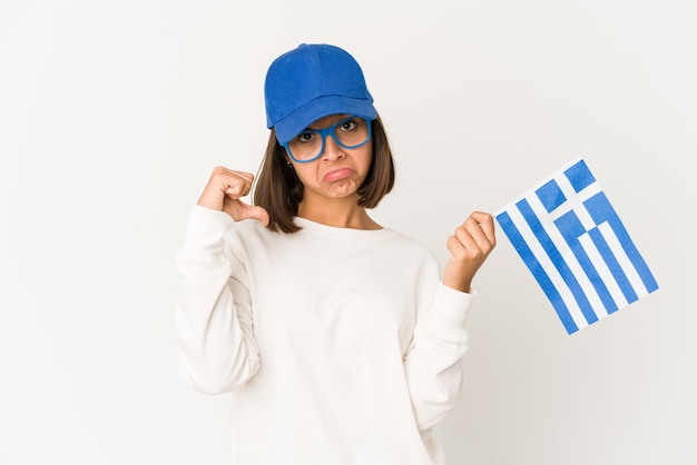 ギリシャの旗を保持している若い女性