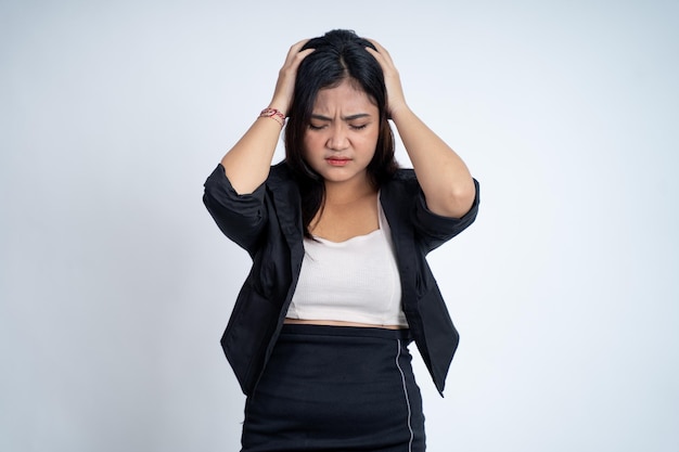 Young woman holding head with headache on isolated background