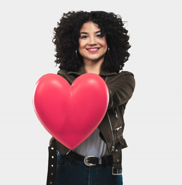 Young woman holding a heart shape