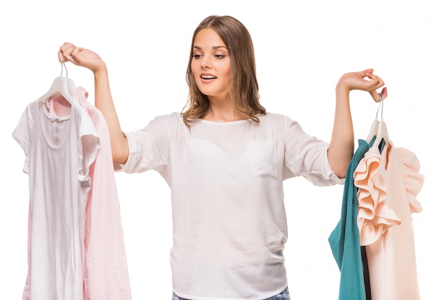 Young woman holding her new dresses.