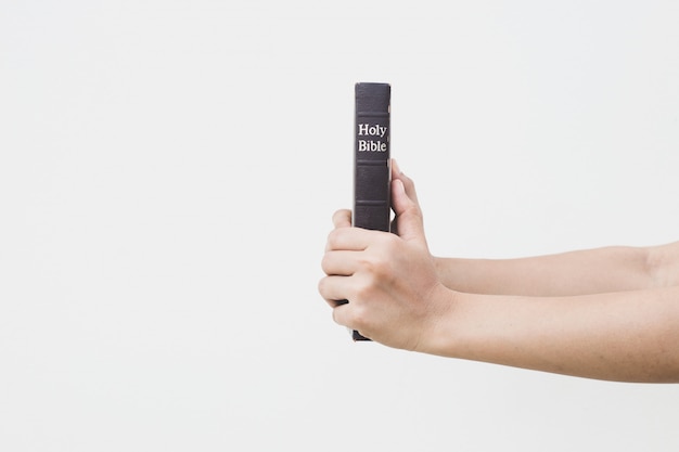 Young woman holding the holy bible in her hands