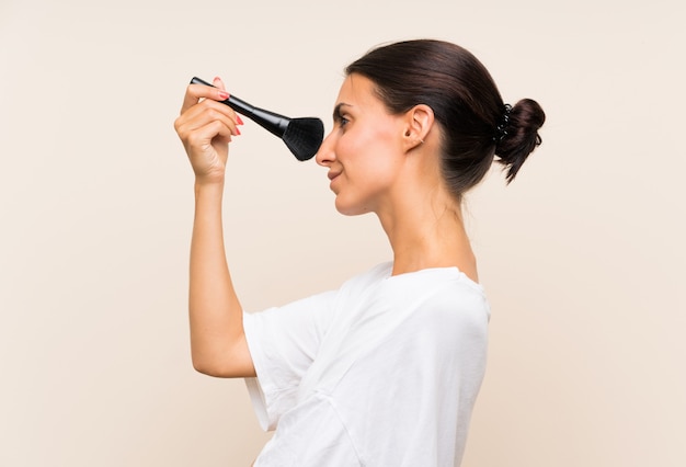 Young woman holding a makeup brush