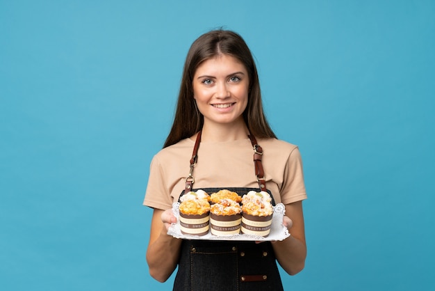 Young woman holding mini cakes