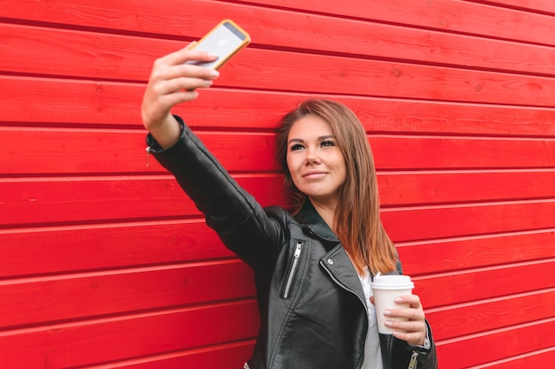 Young woman holding a mobile phone in hands