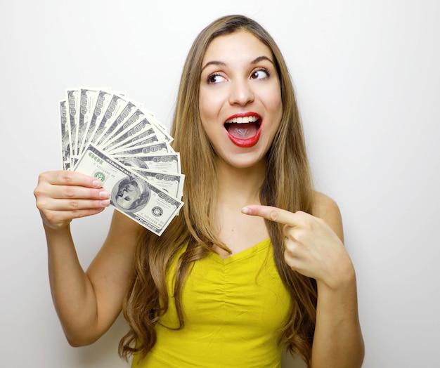 Young woman holding money in her hand