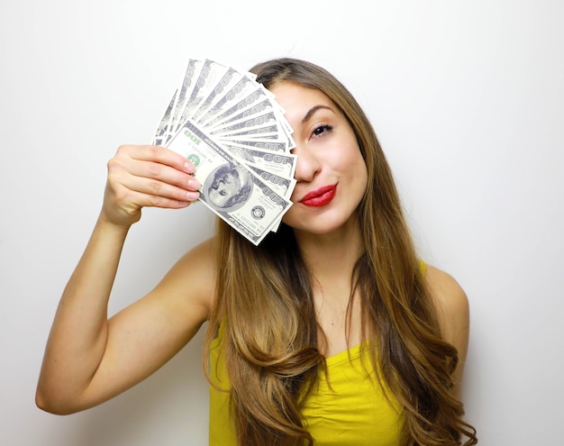 Young woman holding money in her hand