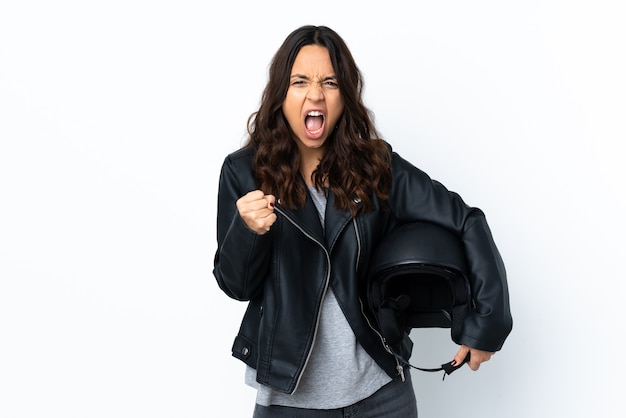 Young woman holding a motorcycle helmet over isolated white background frustrated by a bad situation