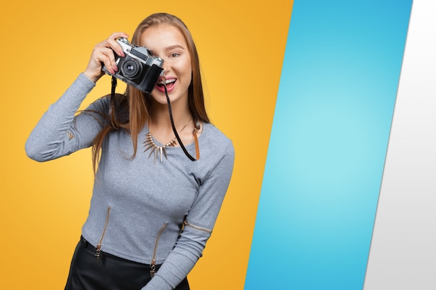 Young woman holding old fashioned camera