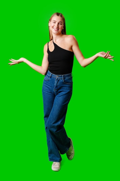 Young woman holding out hands against green background