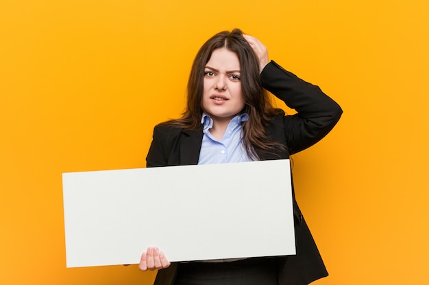 Young woman holding a placard being shocked, she has remembered important meeting.