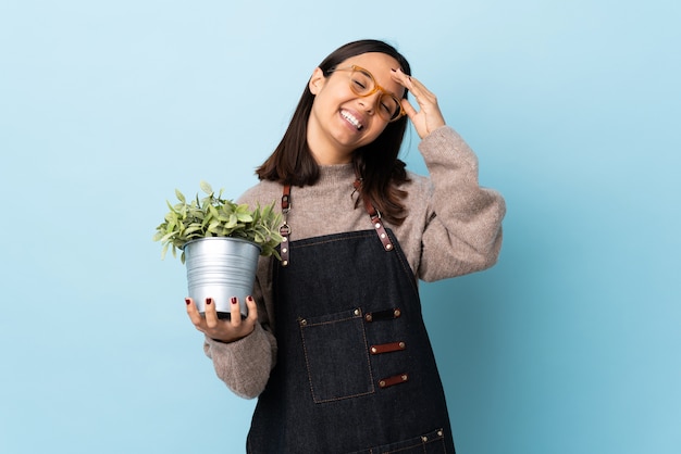 Young woman holding a plant