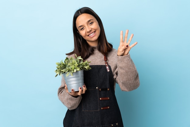 Young woman holding a plant