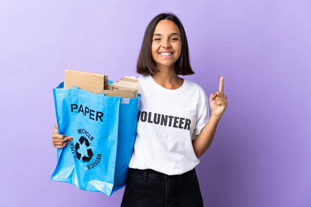 Young woman holding a recycling bag