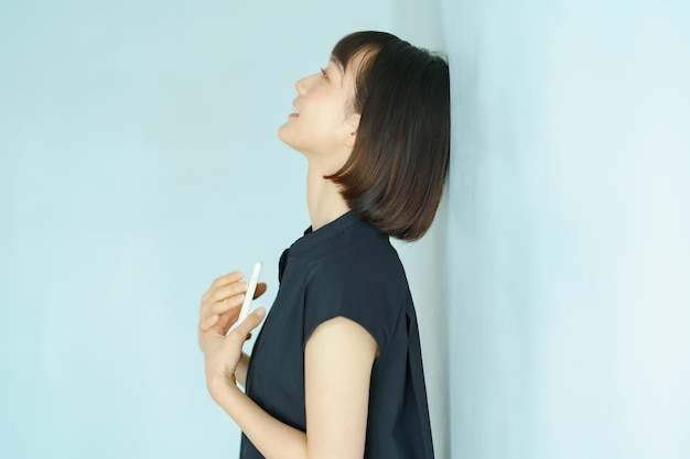 Young woman holding a smartphone indoors