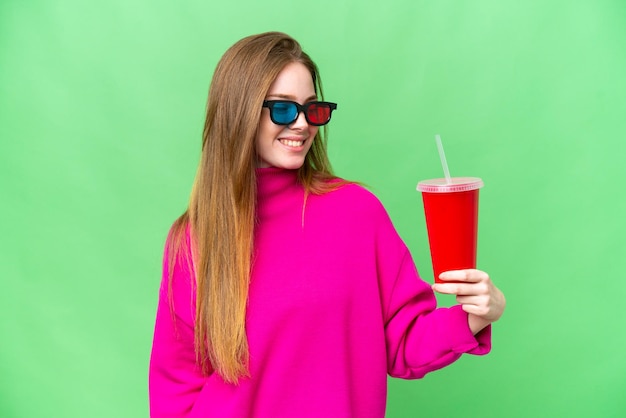 Young woman holding soda while watching a 3D movie with happy expression