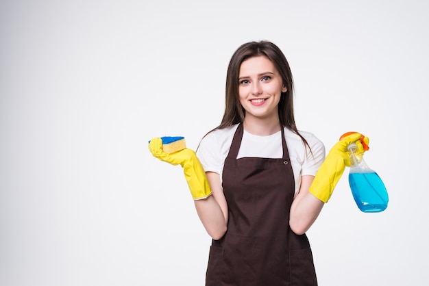 Young woman holding sponge and cleaning product