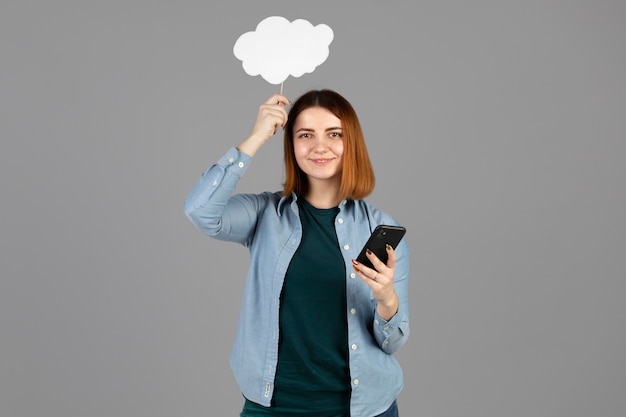 Young woman holding a thought bubble