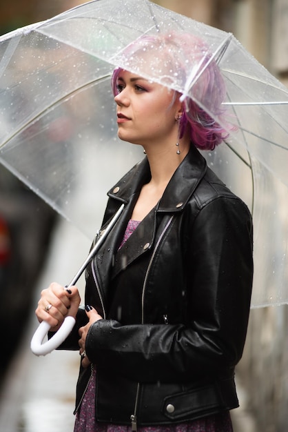 Young woman holding umbrella Autumn city background