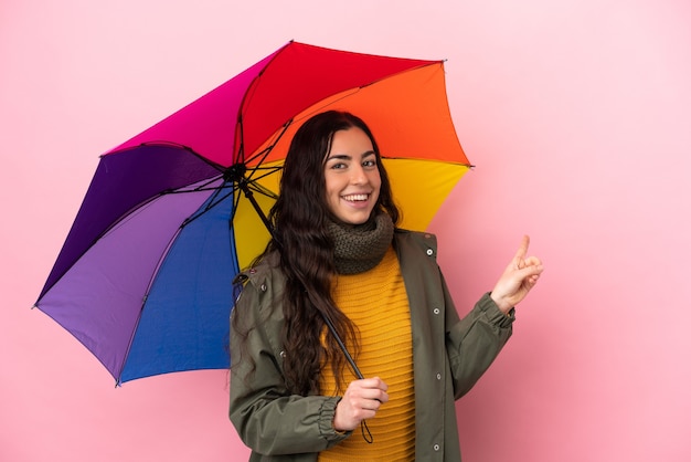 Young woman holding an umbrella isolated